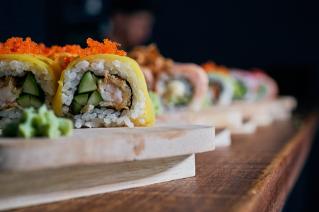 Various kinds of sushi served on wooden tableの写真素材