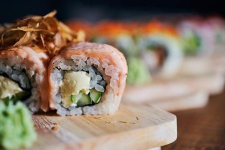 Various kinds of sushi served on wooden tableの写真素材