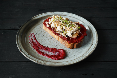 Beetroot humus with toast, chickpea and sesame seeds over wooden surface, top viewの写真素材