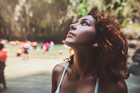 Close up portrait of a beautiful young woman enjoyinga and looking upの写真素材