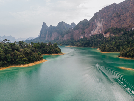 Aerial view of Cheo Lan lake in Thailand. Green mountains and dramatic sky. Travel Thailandの写真素材