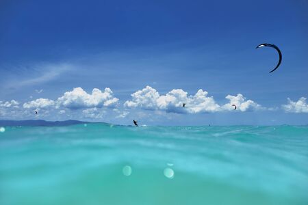 A group of kite surfers in the seaの写真素材