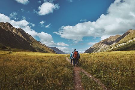 Amazing Landscape of hikers walking up a mountain trail, clouds in a gorge in the background. Bzerpinskiy Karnizの写真素材