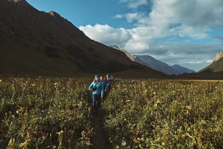 Bzerpinskiy Karniz, a group of hikers walking down a mountain trailの写真素材