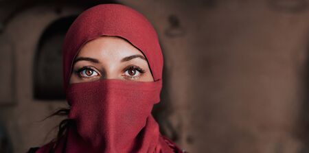 beautiful arabic woman in red hijab with bright makeupの写真素材