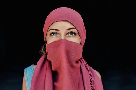 beautiful arabic woman in red hijab with bright makeupの写真素材
