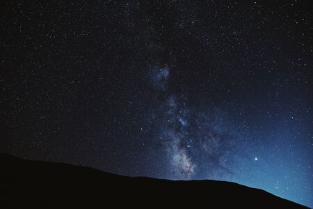 Astrophotography. Milky way with mountains silhouette