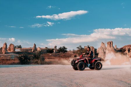 Young woman in safari trip through desert driving Quad ATV. Cappadocia Turkeyの写真素材