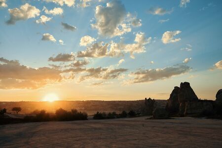 Golden hour on sandy hill in Cappadocia
