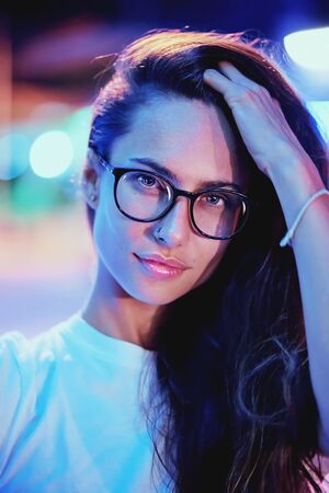 Beautiful girl with glasses at night, fashion photoの写真素材
