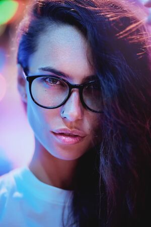 Beautiful girl with glasses at night, fashion photoの写真素材