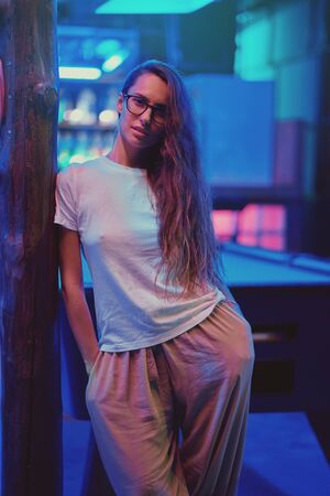 Beautiful girl with glasses at night, fashion photoの写真素材
