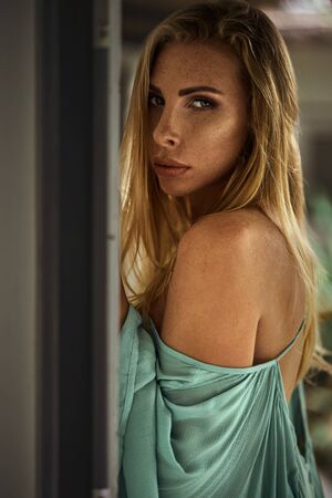 Fashion photo of beautiful young woman wearing green dressの写真素材