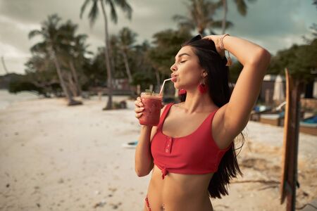 Beautiful young woman drink fruit shakeの写真素材