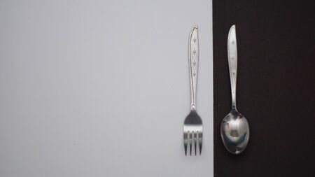 a set of cutlery seen in the picture contained a cutlery and a plate with a black and white...