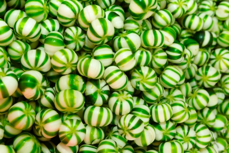 Candy for sale are sorted into pots, these on are greenの写真素材