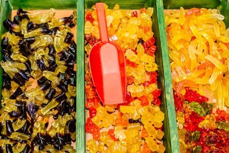 gummy candies for sale are sorted into potsの写真素材