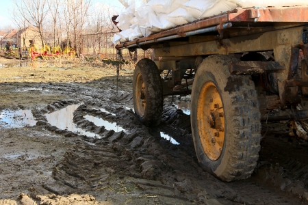 trailer loaded with bags stuck in the mudの写真素材