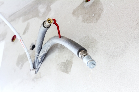 Pipes coming out of a new wall with insulated, a copper water pipe.の写真素材