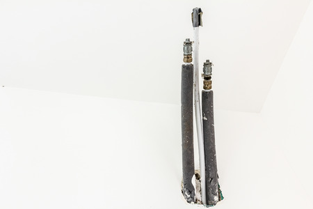Pipes coming out of a new wall with insulated, a copper water pipe.