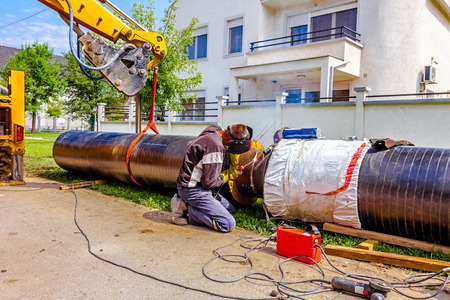 Work is in progress, welding pipeline in urban area.