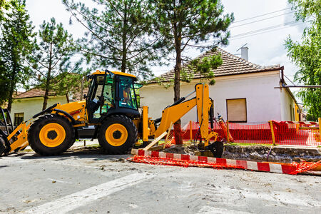 Excavator on new construction site, in the background the blue sky.