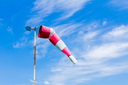 The control of a wind direction, windsock inflated by the wind on the cloudy sky