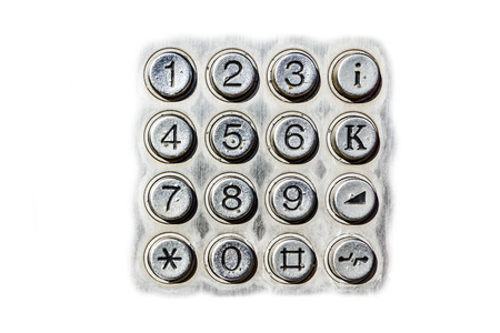 Public telephone keypad is isolated on white background, close shoot.の写真素材