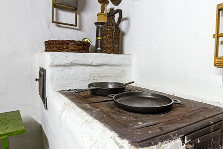 Cooking in a frying pan on old stove at antique kitchen.の写真素材