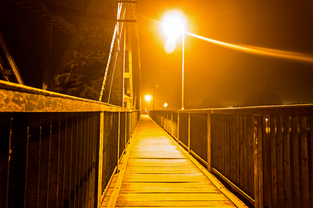 Railway bridge with path for pedestrians made of steel profiles attached with bolts and rivets.の写真素材