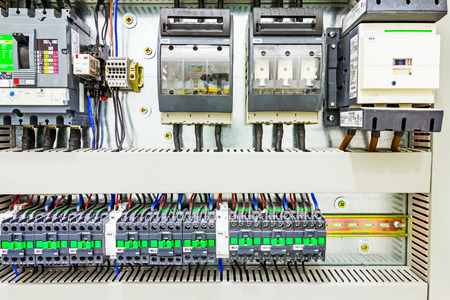 Automatic programming relay has control over electrical panel, power lines located inside of the...