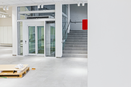 View on staircase and glass elevator in a modern business centre.