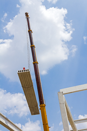 Mobile crane is carry concrete joist to assembly huge hall.の写真素材