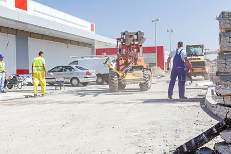 View on construction site with machinery, people at work. Landscape transform into large urban area.のeditorial素材