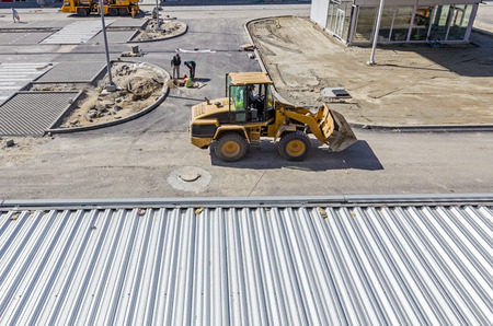 Landscape transform into urban area with machinery, people are working. View on construction site.
