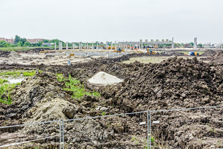 Landscape transform into urban area with machinery, people are working. View on construction site.の写真素材