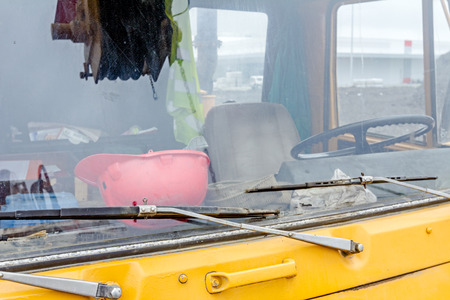 Front view cabin of the yellow mobile crane with winch in reflection on windscreen glass.の写真素材