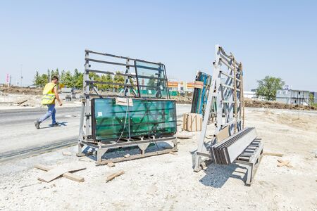 Pallet with thermo window glasses in construction site waiting for built in. Double glazed glass...