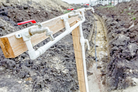 Several faucets with fresh water are placed temporarily at construction site for washing worker's...