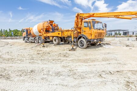 Truck mixer is pouring concrete into concrete pump for casting.