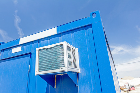 Outdoor unit, compressor, of air conditioner is placed on container office.の写真素材