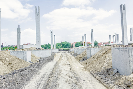 Tire tracks of large vehicles in dry ground on a building area foundation of new building construction.の写真素材