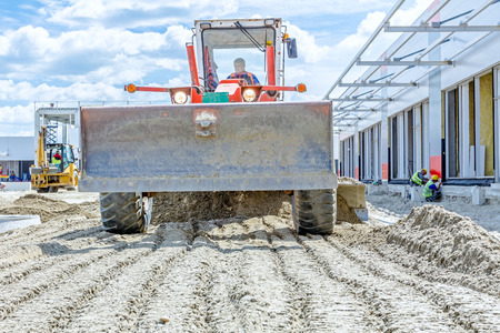 Zrenjanin, Vojvodina, Serbia - June 29, 2015: Low angle view on red grader until is leveling ground...