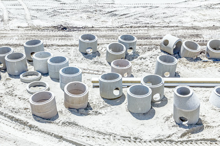 New concrete prefabricated pipes for manhole or drainage stacked at building siteの写真素材