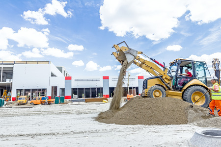 Zrenjanin, Vojvodina, Serbia - June 29, 2015: View on backhoe while he piles up ground at construction site.のeditorial素材