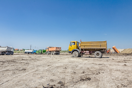 Big hydraulic dump truck is moving into reverse, prepare to unload cargo.の写真素材