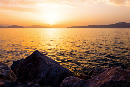 Scenic view of beautiful sunset in the evening time over the sea, water, sky and stone.の写真素材