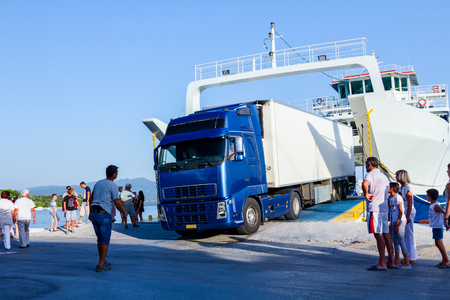 Pefki, Island Evia, Greece - 11, July 2017: Anchored large ferryboat has opened his front entrance for unloading vehicles at the local harborのeditorial素材