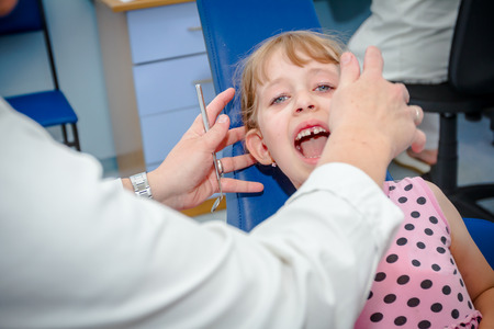Portrait of sweet little girl at the oral examination.の写真素材