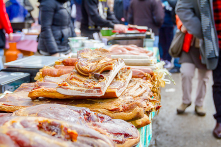 Bunch of cured bacon, meat for sale at outdoor flea market.の写真素材